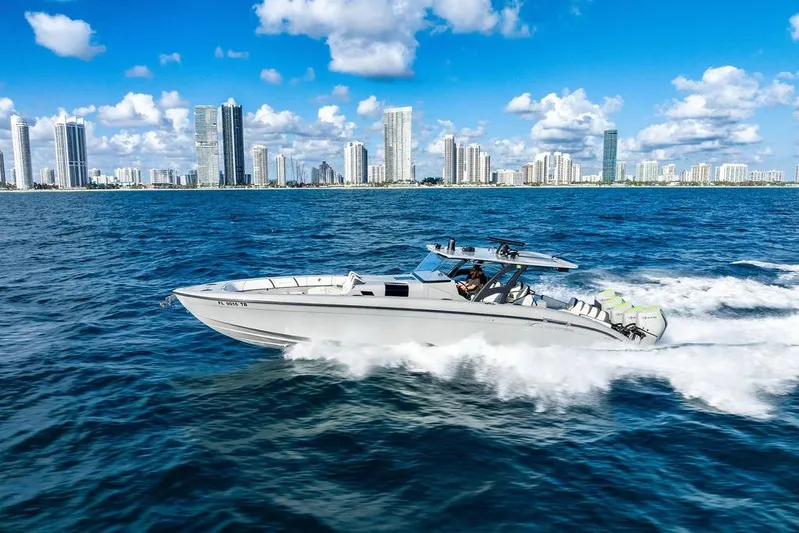 Trigger Yacht Photos Pics 2022 Midnight Express 43' Solstice cruising near city skyline on a sunny day.