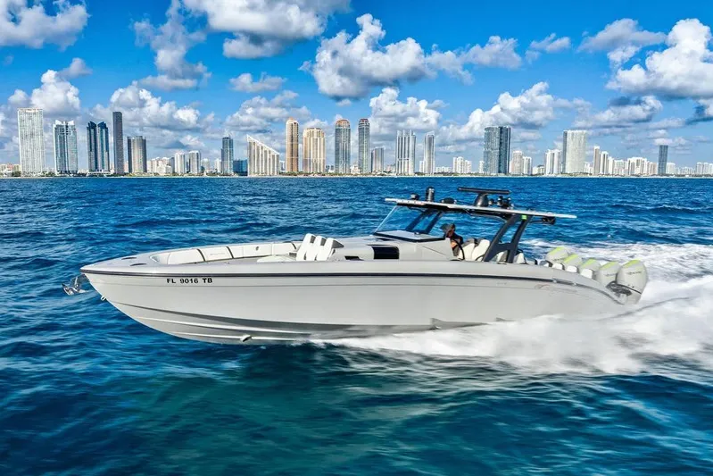 Trigger Yacht Photos Pics 2022 Midnight Express 43' Solstice boat cruising near city skyline on a sunny day.