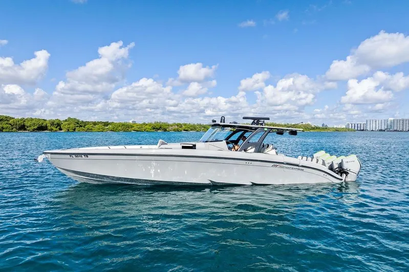 Trigger Yacht Photos Pics 2022 Midnight Express 43' Solstice boat on clear blue water under a sunny sky.