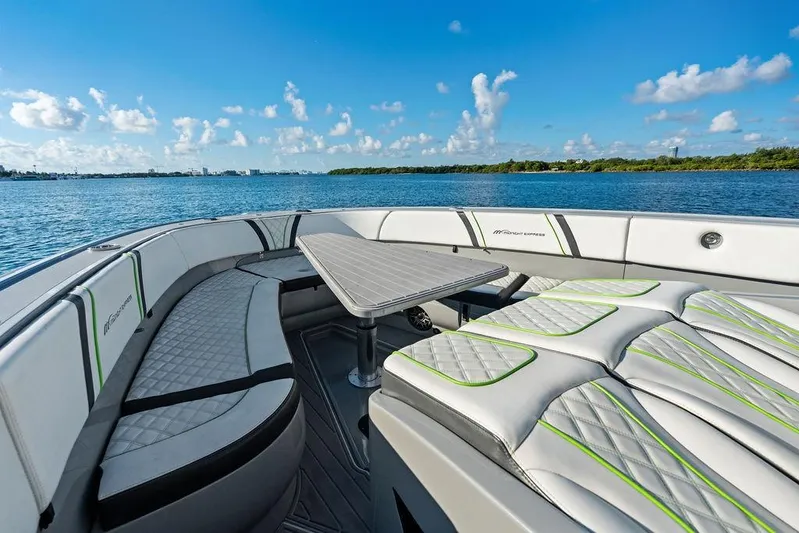 Trigger Yacht Photos Pics Luxurious 2022 Midnight Express 43' Solstice boat interior with seating and table on a sunny day.