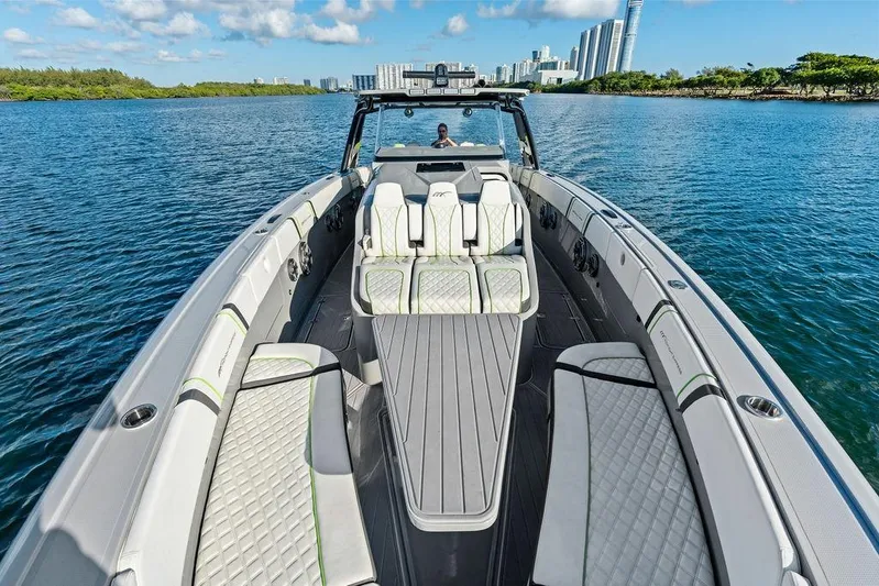Trigger Yacht Photos Pics 2022 Midnight Express 43' Solstice luxury boat on calm water with city skyline.