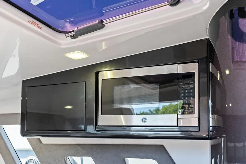 Trigger Yacht Photos Pics Modern kitchen area in 2022 Midnight Express 43' Solstice boat with built-in microwave.