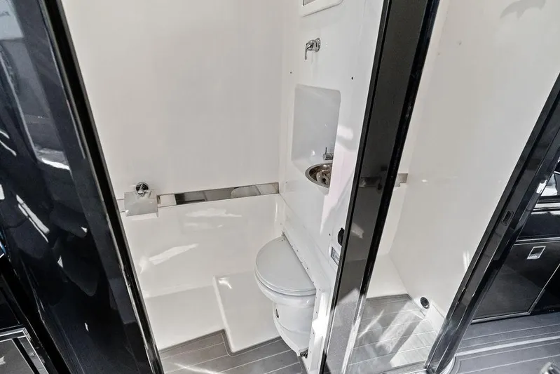 Trigger Yacht Photos Pics Modern bathroom in 2022 Midnight Express 43' Solstice boat, featuring sleek design and compact amenities.