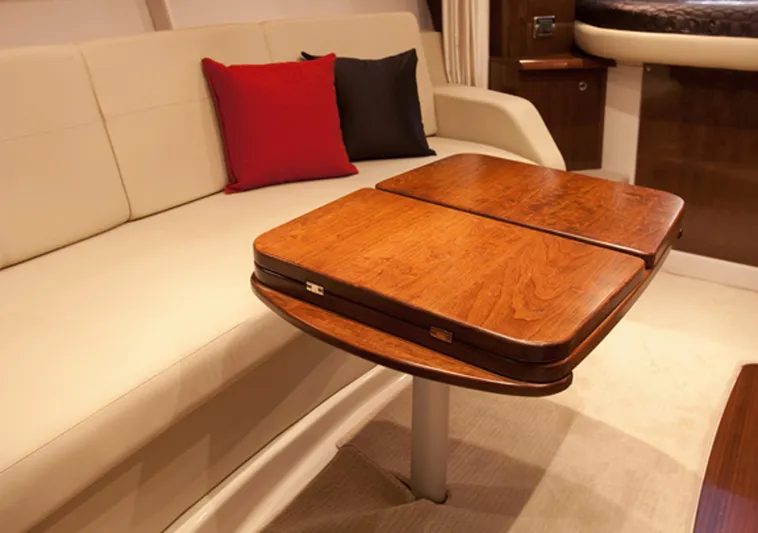  Yacht Photos Pics Manufacturer Provided Image: Interior of 2013 Four Winns Vista 375 with wooden table and beige seating.