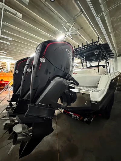  Yacht Photos Pics 2020 Nor-Tech 390 Sport Center Console with powerful outboard engines in a garage setting.