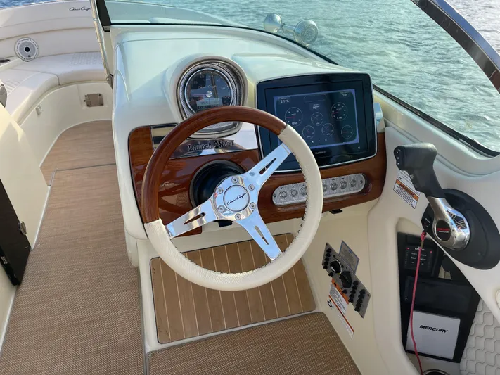  Yacht Photos Pics 2021 Chris-Craft 28 Launch GT boat dashboard with steering wheel and Garmin display.