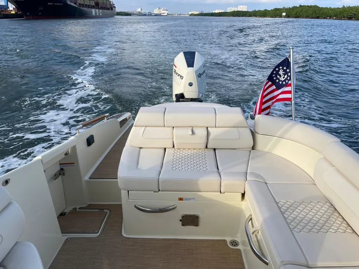  Yacht Photos Pics 2021 Chris-Craft 28 LAUNCH GT boat interior with American flag, cruising on water.