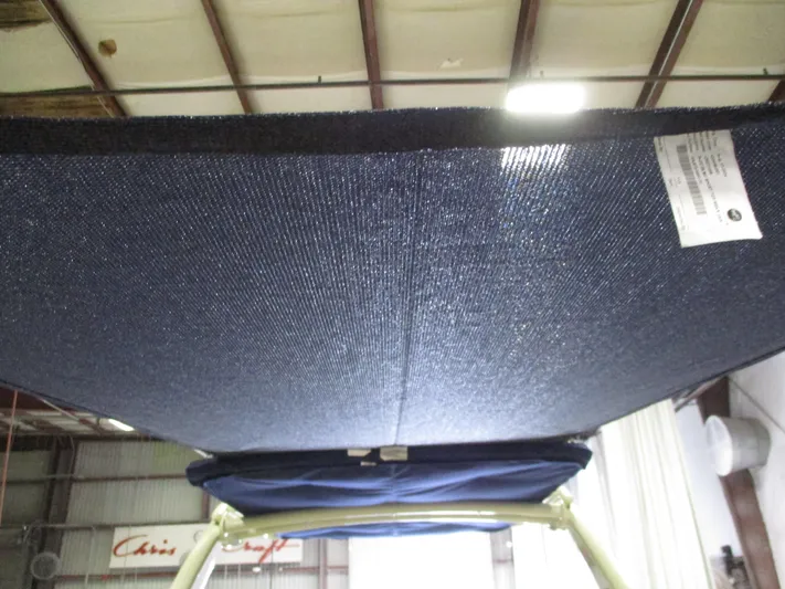  Yacht Photos Pics 2021 Chris-Craft 28 LAUNCH GT boat canopy under view in a warehouse.