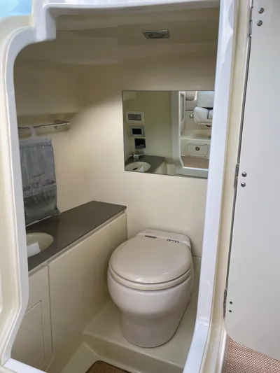  Yacht Photos Pics 2021 Chris-Craft 28 Launch GT boat bathroom with toilet, sink, and mirror.
