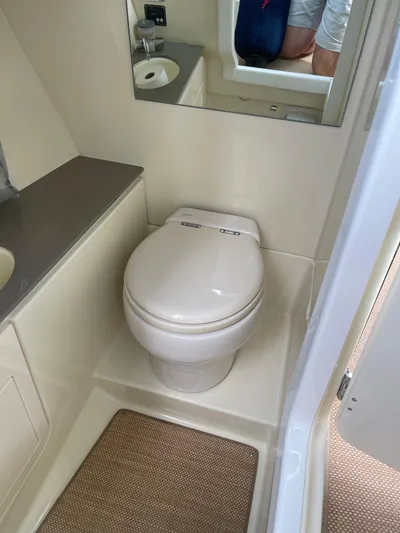  Yacht Photos Pics 2021 Chris-Craft 28 Launch GT boat bathroom with toilet, sink, and mirror.