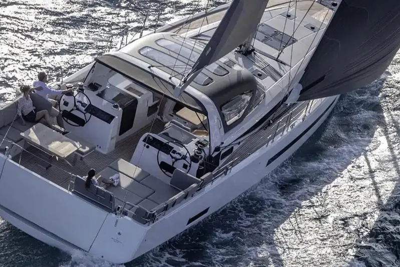 Les Quatre Vents Yacht Photos Pics 2023 Jeanneau 55 sailing yacht cruising on open water, featuring sleek design and dual helm stations.