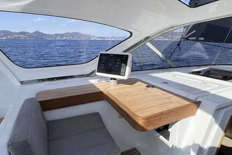 Les Quatre Vents Yacht Photos Pics Modern interior of 2023 Jeanneau 55 yacht with navigation display and ocean view.