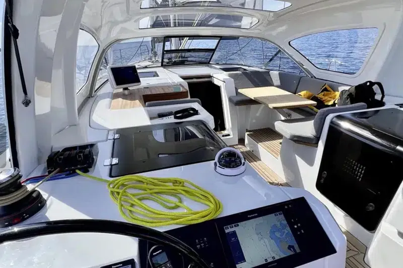 Les Quatre Vents Yacht Photos Pics Interior view of 2023 Jeanneau 55 yacht with modern navigation equipment and seating area.