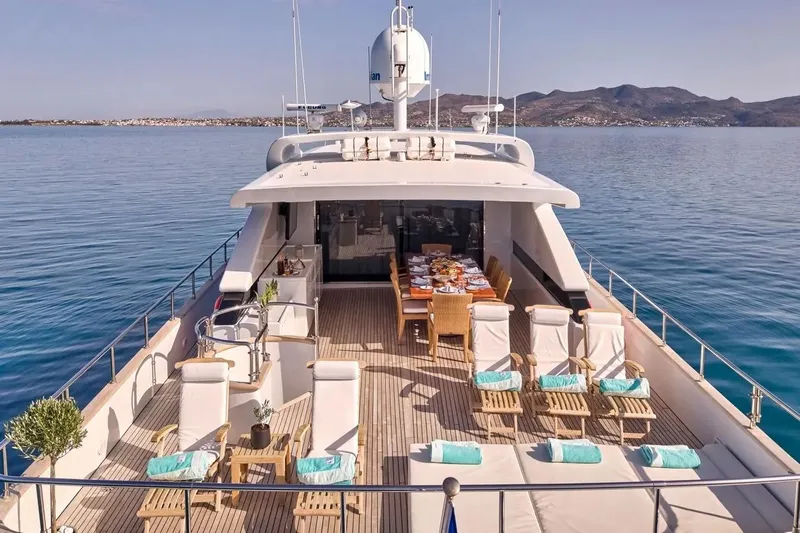 Let It Be Yacht Photos Pics Luxurious 1998 Tecnomarine 118 yacht deck with elegant seating and dining area.