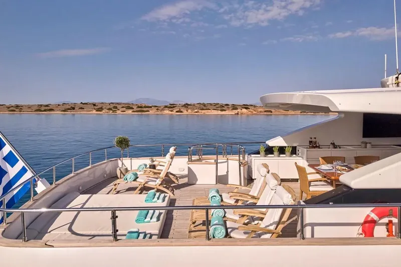 Let It Be Yacht Photos Pics Luxurious Tecnomarine 118 yacht deck with sun loungers and dining area, 1998 model.