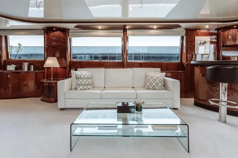 Let It Be Yacht Photos Pics Luxurious Tecnomarine 118 yacht interior, featuring elegant white sofa and glass coffee table, 1998 model.