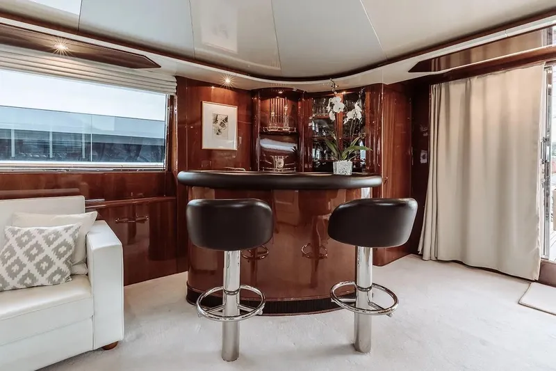 Let It Be Yacht Photos Pics Luxurious interior of 1998 Tecnomarine 118 yacht with elegant bar and seating area.