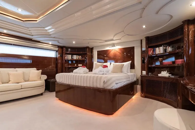 Let It Be Yacht Photos Pics Luxurious Tecnomarine 118 yacht bedroom interior, featuring elegant wood finishes and plush furnishings, 1998 model.