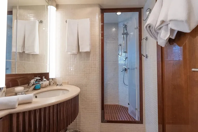 Let It Be Yacht Photos Pics Luxurious Tecnomarine 118 yacht bathroom, featuring elegant fixtures and a modern shower, 1998 model.