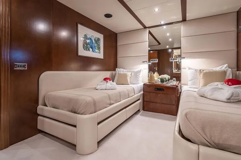 Let It Be Yacht Photos Pics Luxurious Tecnomarine 118 yacht bedroom interior, featuring twin beds and elegant decor, 1998 model.