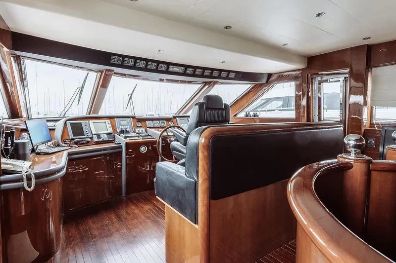 Let It Be Yacht Photos Pics Luxurious 1998 Tecnomarine 118 yacht interior with polished wood and advanced navigation equipment.