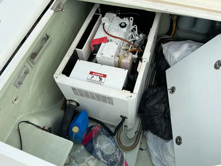The Dance Yacht Photos Pics Engine compartment of a 2019 Leopard 51 Powercat with visible machinery and storage items.