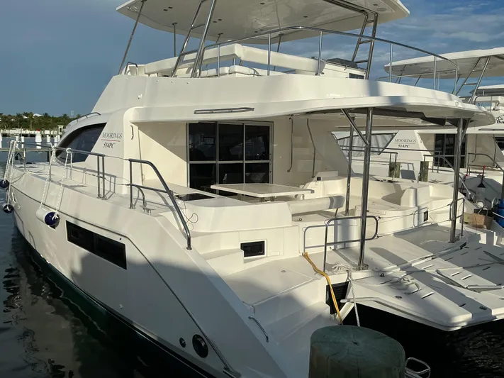 The Dance Yacht Photos Pics 2019 Leopard 51 Powercat yacht docked at marina, showcasing sleek design and spacious deck.
