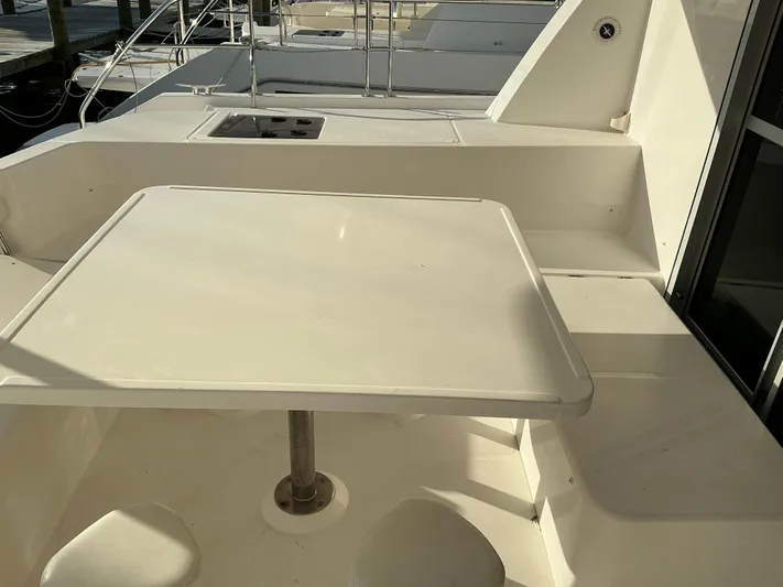 The Dance Yacht Photos Pics 2019 Leopard 51 Powercat deck with white table and seating area.