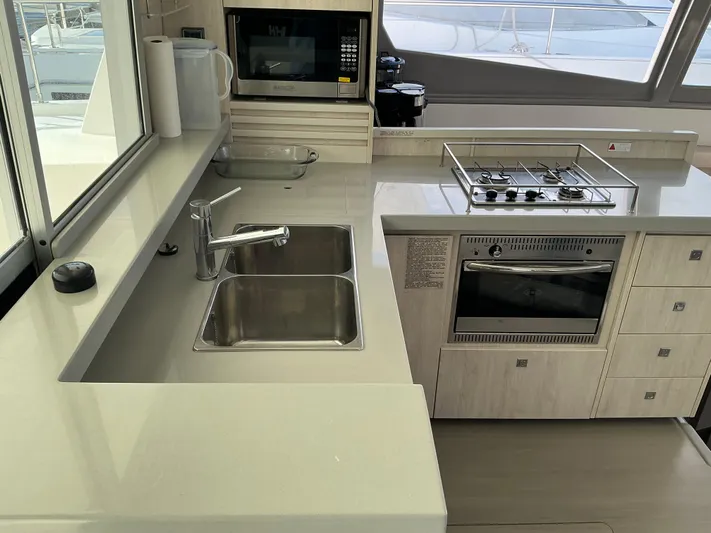 The Dance Yacht Photos Pics Modern kitchen in 2019 Leopard 51 Powercat with sink, stove, and microwave.