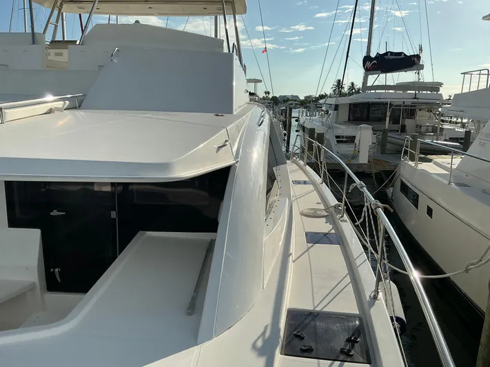 The Dance Yacht Photos Pics 2019 Leopard 51 Powercat yacht docked at marina, showcasing sleek design and spacious deck.