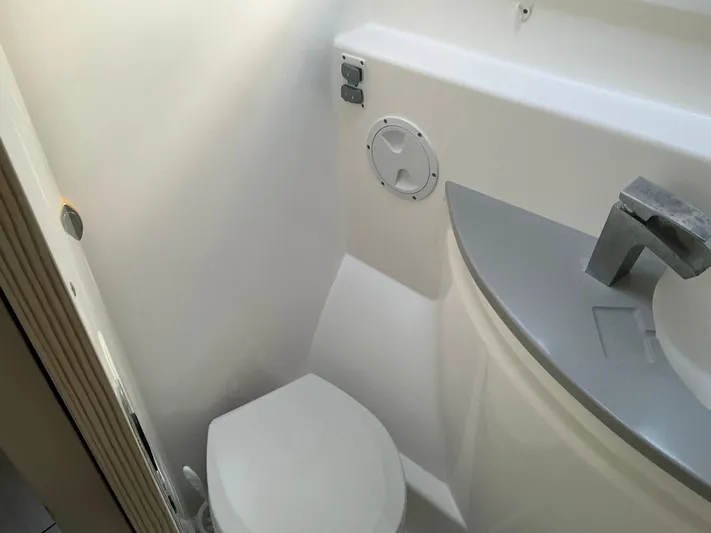 The Dance Yacht Photos Pics Compact bathroom in 2019 Leopard 51 Powercat, featuring modern sink and toilet.