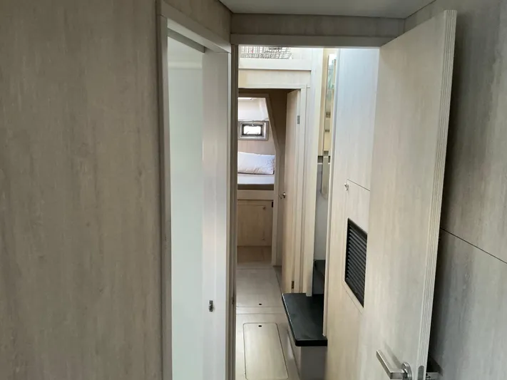 The Dance Yacht Photos Pics Interior hallway of 2019 Leopard 51 Powercat yacht, featuring modern wood paneling.