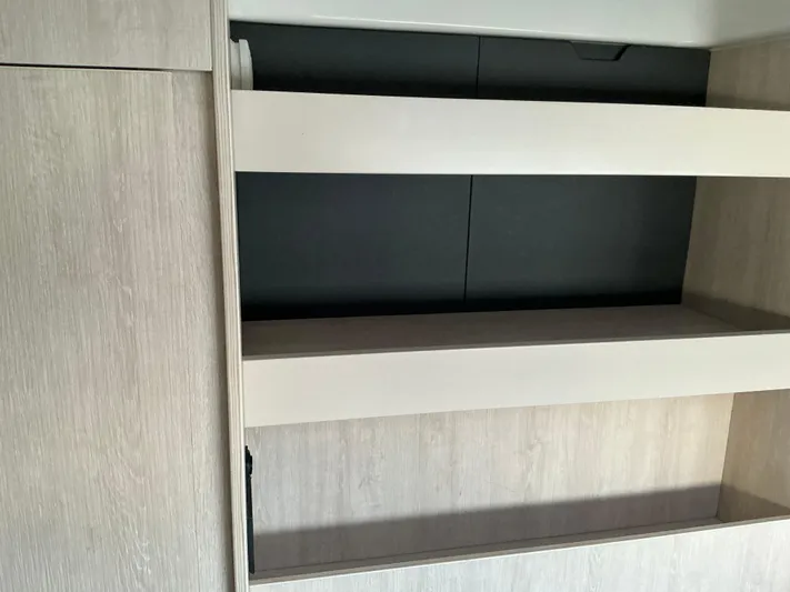 The Dance Yacht Photos Pics Empty wooden shelves inside a 2019 Leopard 51 Powercat yacht interior.