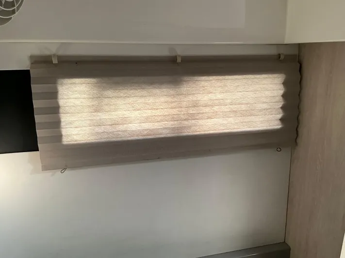 The Dance Yacht Photos Pics Pleated window shade inside a 2019 Leopard 51 Powercat yacht cabin.