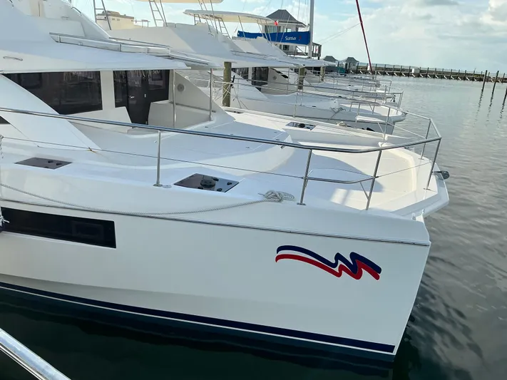 The Dance Yacht Photos Pics 2019 Leopard 51 Powercat yacht docked at marina, featuring sleek design and spacious deck.