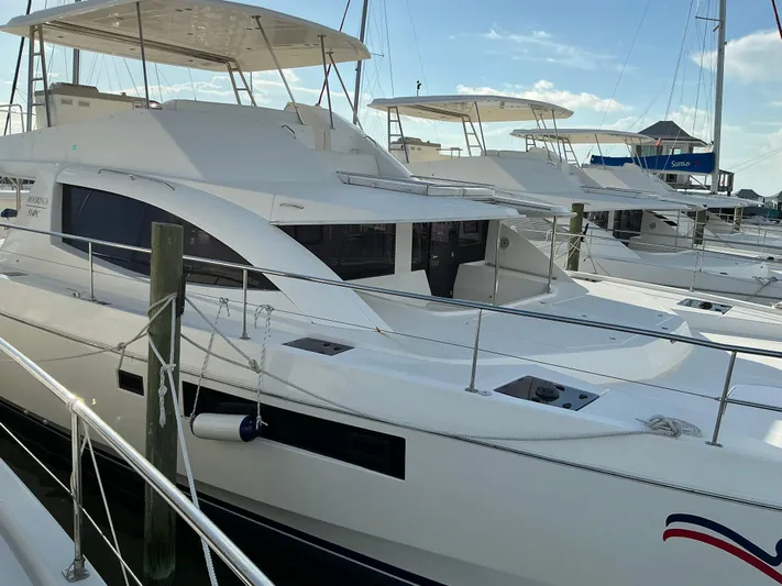 The Dance Yacht Photos Pics 2019 Leopard 51 Powercat docked at marina, showcasing sleek design and spacious deck.