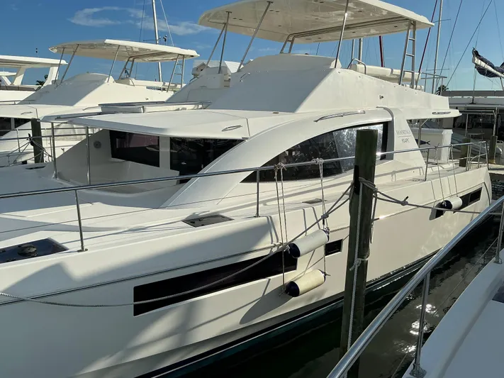 The Dance Yacht Photos Pics 2019 Leopard 51 Powercat yacht docked in marina under clear blue sky.