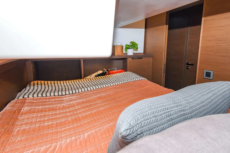  Yacht Photos Pics Cozy bedroom interior of 2021 Lagoon 50 yacht with modern wood finish.
