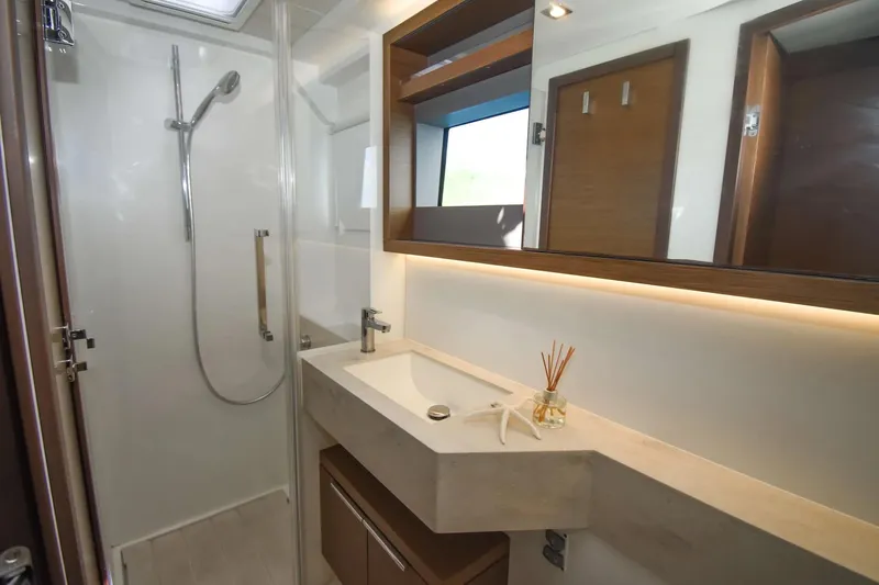  Yacht Photos Pics Modern bathroom interior on 2021 Lagoon 50 yacht, featuring sleek shower and elegant sink.