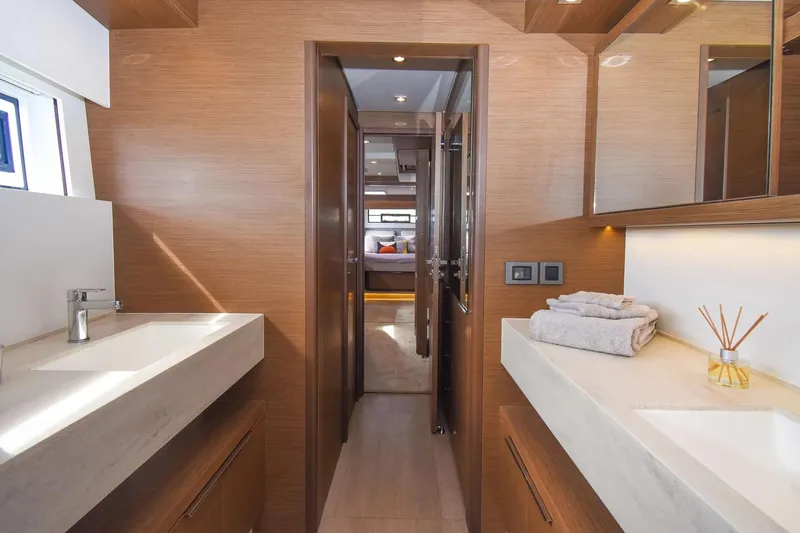  Yacht Photos Pics Luxurious bathroom interior of 2021 Lagoon 50 yacht with modern fixtures and wooden accents.