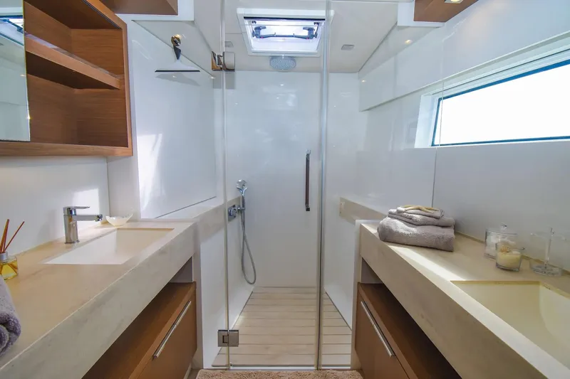  Yacht Photos Pics Luxurious bathroom interior of 2021 Lagoon 50 yacht with dual sinks and modern shower.