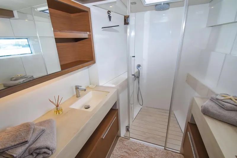  Yacht Photos Pics Luxurious bathroom in 2021 Lagoon 50 yacht with modern fixtures and spacious shower.