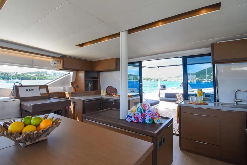  Yacht Photos Pics Luxurious interior of 2021 Lagoon 50 yacht with modern kitchen and scenic ocean view.