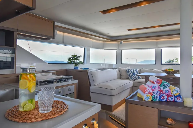  Yacht Photos Pics Luxurious interior of 2021 Lagoon 50 yacht with modern kitchen and cozy seating area.