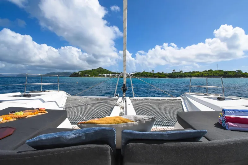  Yacht Photos Pics Luxurious 2021 Lagoon 50 catamaran with scenic ocean view and comfortable deck seating.