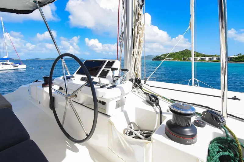  Yacht Photos Pics 2021 Lagoon 50 yacht helm with ocean view, featuring modern navigation equipment.