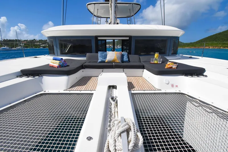  Yacht Photos Pics Luxurious 2021 Lagoon 50 catamaran with sunbathing area and scenic ocean view.