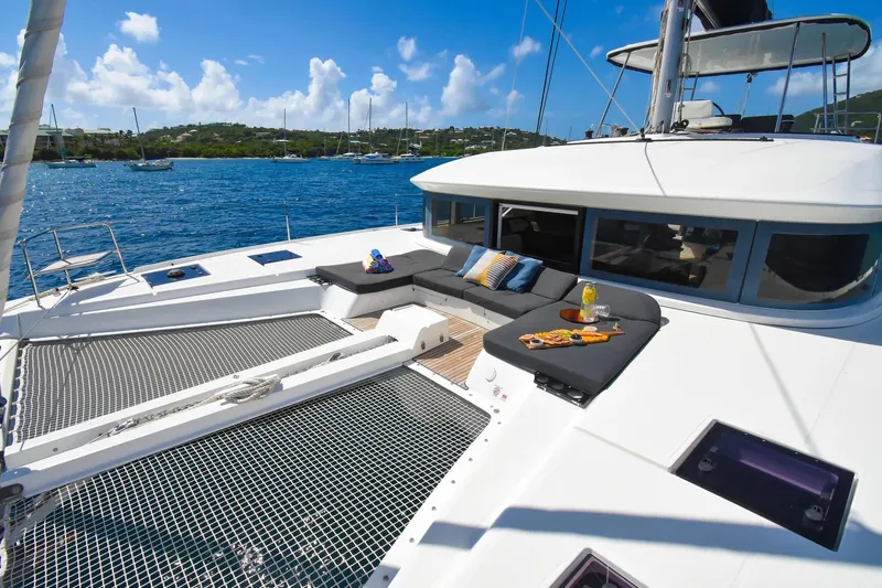  Yacht Photos Pics Luxurious 2021 Lagoon 50 catamaran with sunbathing area and scenic ocean view.
