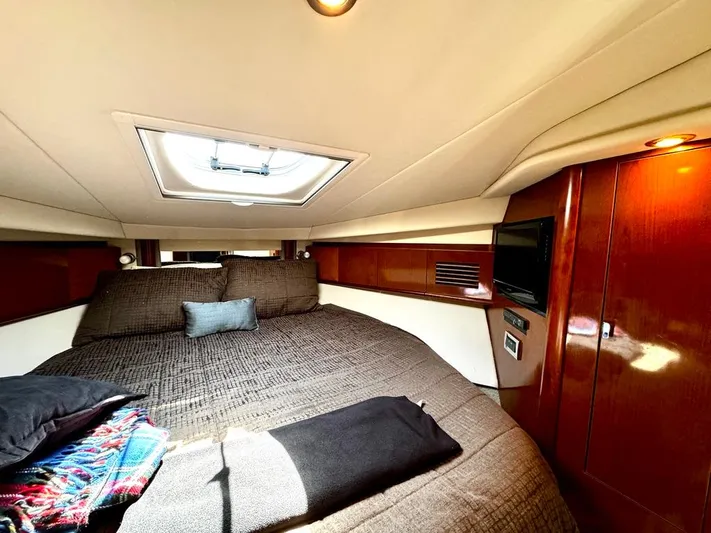  Yacht Photos Pics Luxurious cabin interior of 2010 Sea Ray 40 Sundancer yacht with skylight and cozy bedding.
