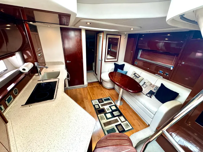  Yacht Photos Pics Luxurious interior of 2010 Sea Ray 40 Sundancer yacht with modern kitchen and seating area.